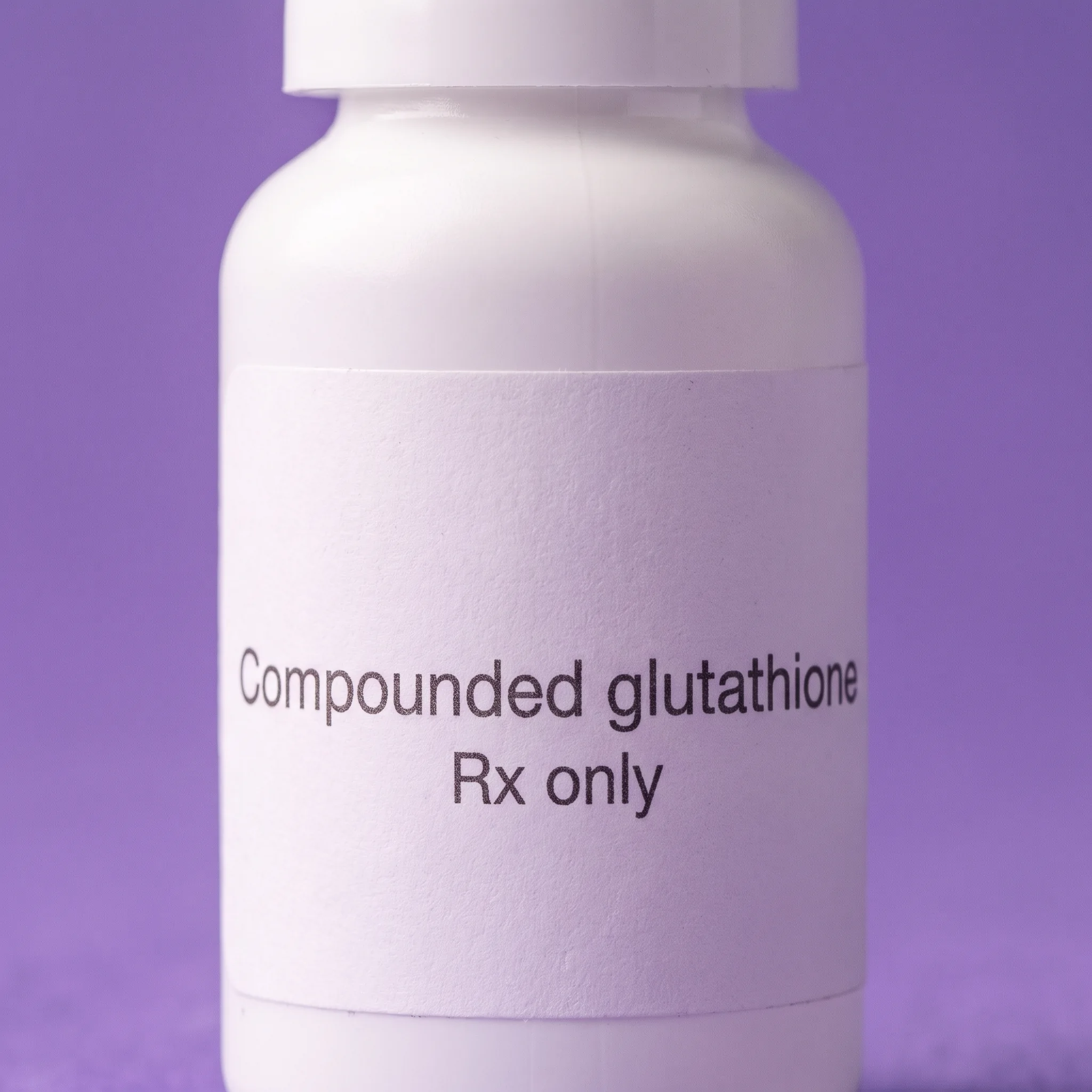 Macro detail of the plain white label, reading Compounded glutathione above Rx only