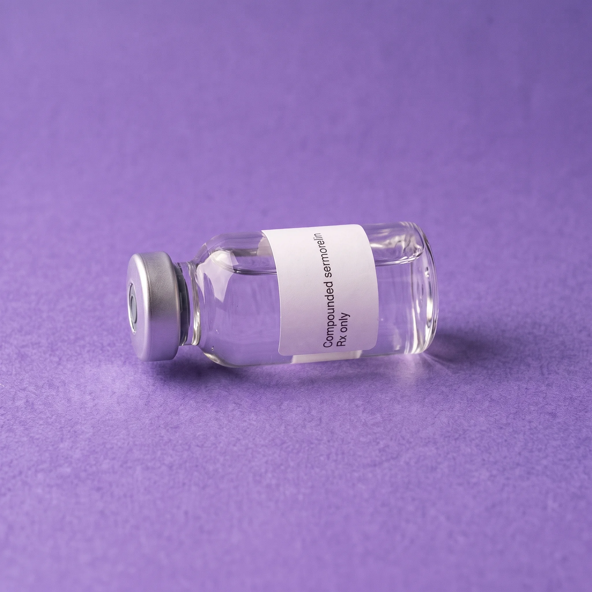 The Compounded sermorelin vial laid on its side on iris paper