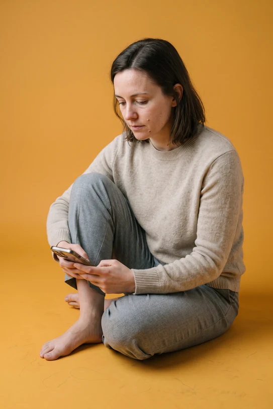 Someone sitting on amber seamless, working through the online visit on a phone